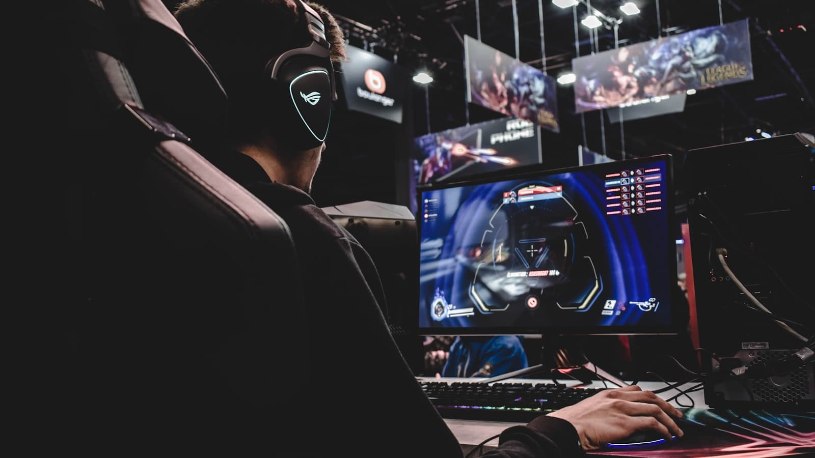 Creator wearing a headset working at a multi-monitor setup with colorful screens