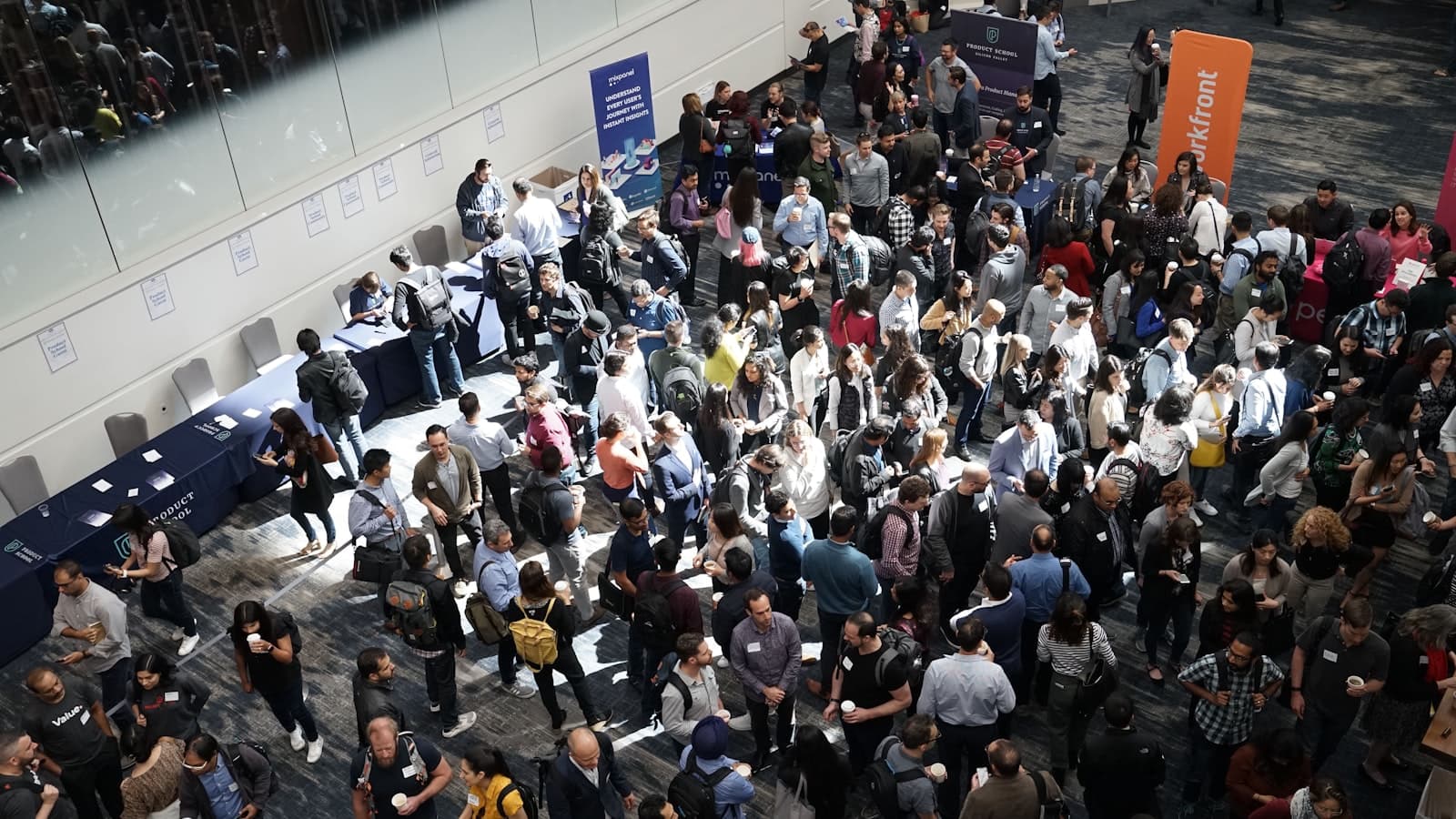 Overhead view of a large crowd of people gathered in a conference hall